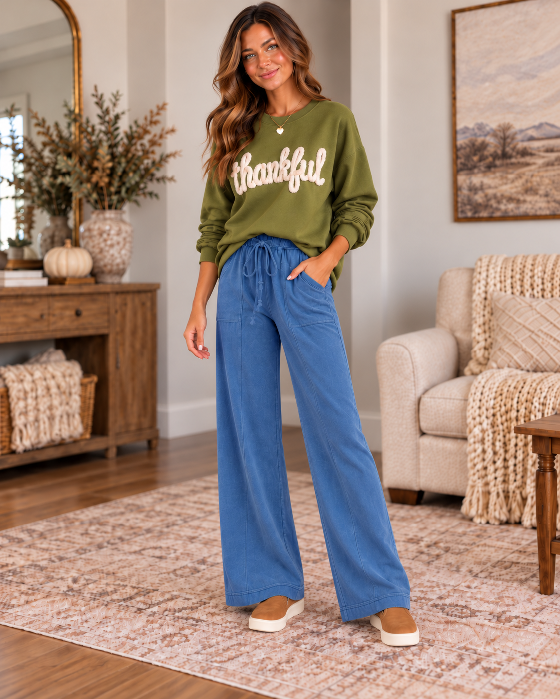 Featured Look: The Simply Thankful Edit — olive green thankful sweatshirt, blue wide-leg pants, tan sneakers, gold heart necklace